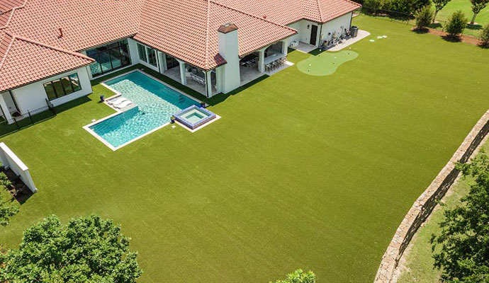 Aerial view of luxury backyard artificial turf and putting green