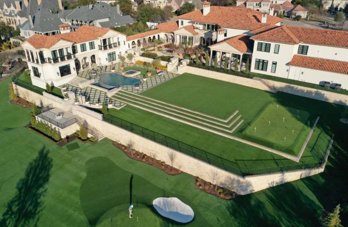 Aerial view of luxury estate with tiered synthetic turf and putting green