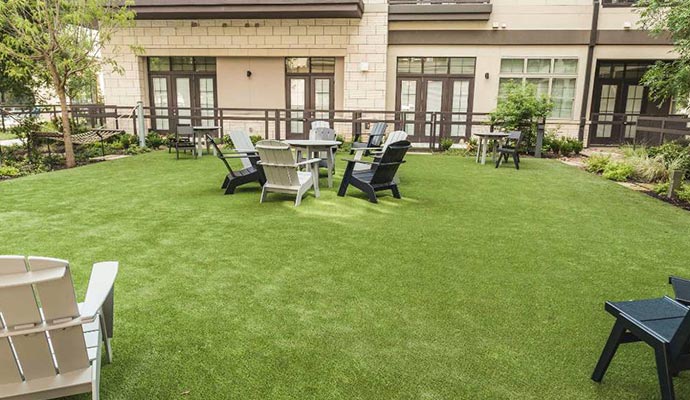 Courtyard with artificial turf and outdoor seating.