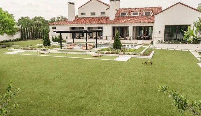 Artificial turf installed in a home backyard for a lush, green look