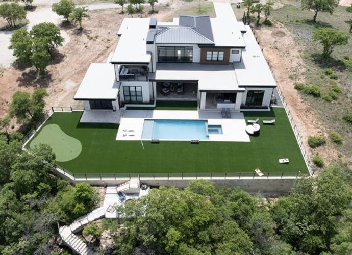 Installed synthetic grass around pool area at the back of the home