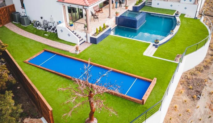 Bocce ball court installed in the backyard of a residential house.