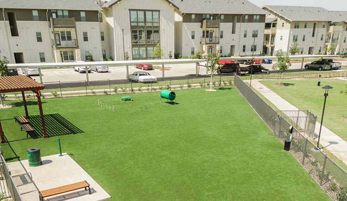 Commercial dog park with artificial turf at an apartment complex