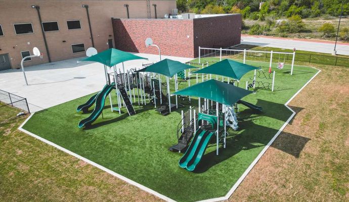 Commercial property playground with synthetic grass