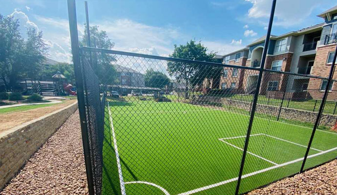 Basketball court with artificial turf at an apartment complex.