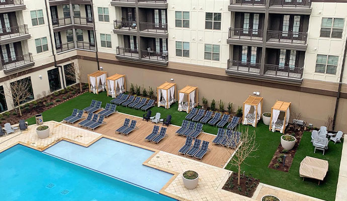 Commercial hotel pool area with installed synthetic turf
