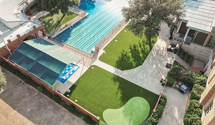 Commercial synthetic grass surrounding club pool and courtyard