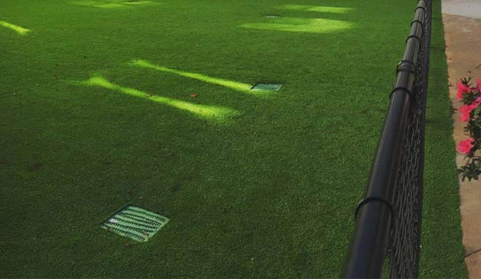 Drainage grates installed in synthetic turf lawn
