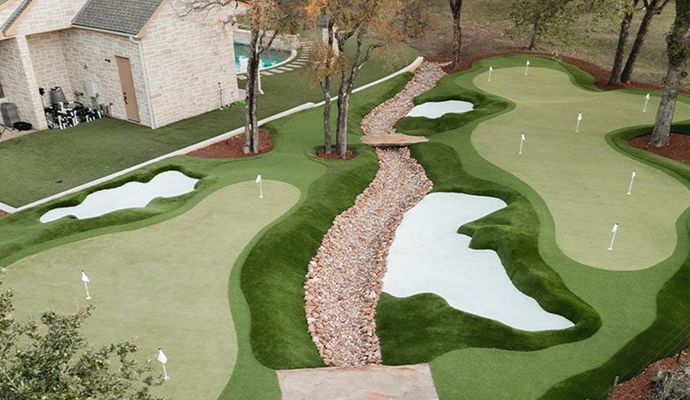 Installed artificial turf near trees for backyard golf practice
