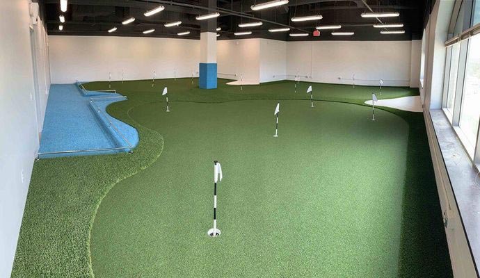 Large indoor artificial turf putting green.