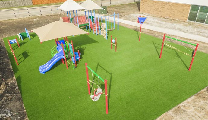 Aerial view of a new school playground with artificial turf.