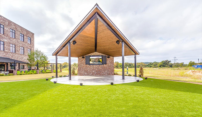 Outdoor event venue pavilion stage with synthetic turf