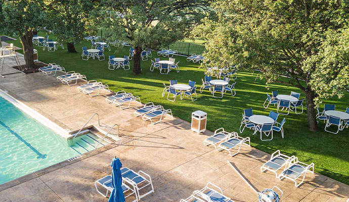 Swimming pool and outdoor dining area with synthetic turf