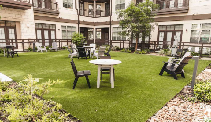 Apartment courtyard with durable turf installation outdoor seating
