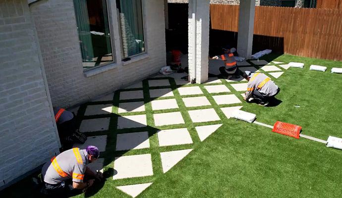Experts installing turf