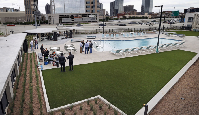Hotel pool area with installed synthetic turf lawn