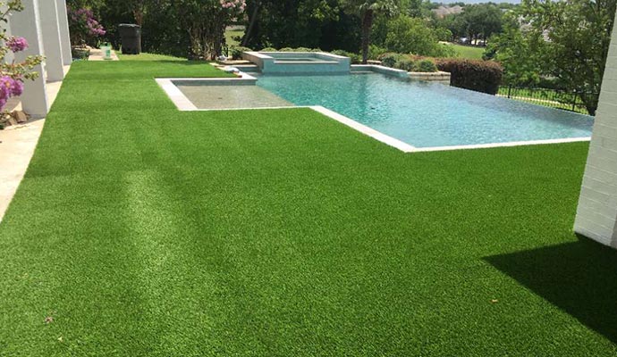 Installed synthetic turf beside pool