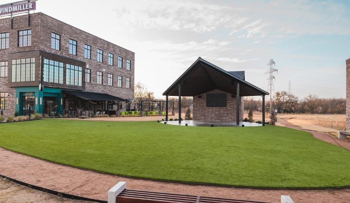 Event space featuring synthetic grass for low-maintenance flooring