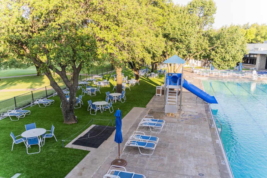 Poolside area with artificial grass lawn