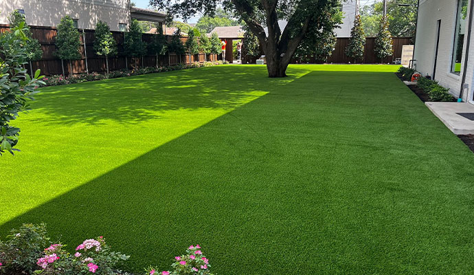 Maintained artificial grass lawn in backyard