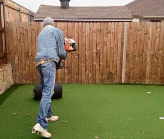 Maintaining artificial turf with power broom