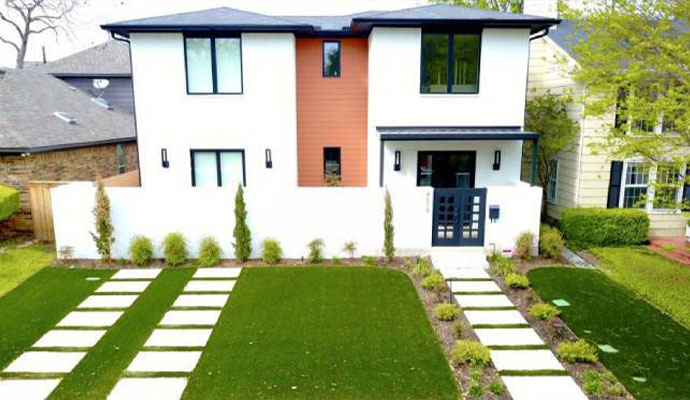 Modern home front yard with artificial grass and paver walkways
