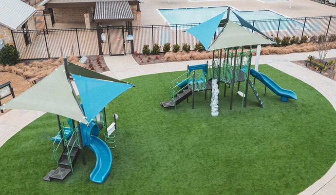 Aerial view of a community playground featuring artificial turf