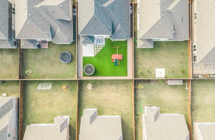 Residential backyard playground strips pavers riverrock birdseye view