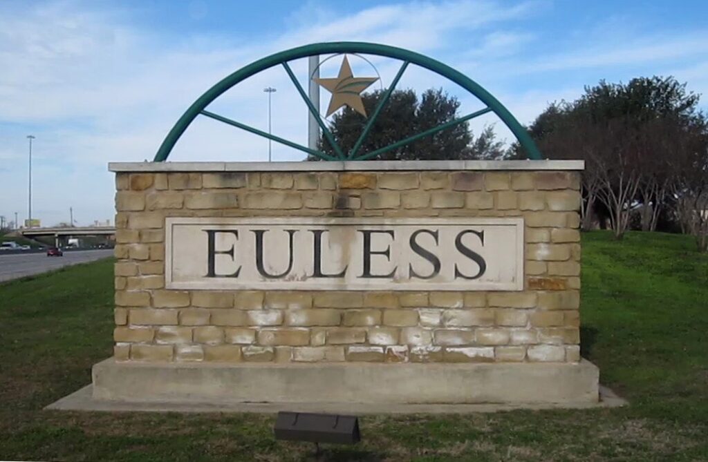 Euless, Texas city sign with Euless Artificial Grass surrounding the sign